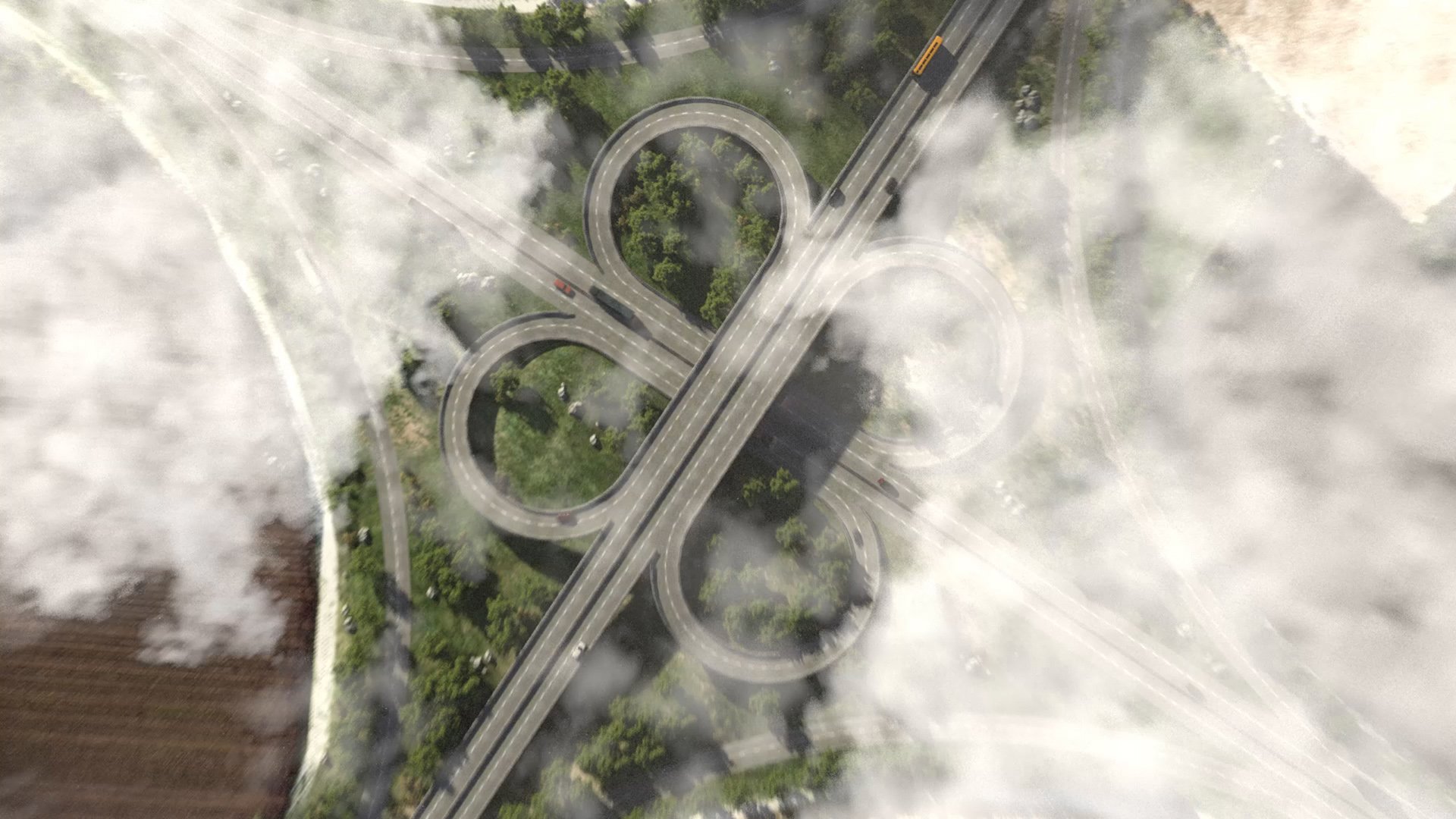 Drohnenperspektive auf ein komplexes Autobahnkreuz mit klaren Fahrspuren und Verkehrsmustern.
