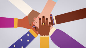 Eine Gruppe von Menschen hält sich an den Händen. Gemeinschaft und Zusammenhalt werden symbolisiert.